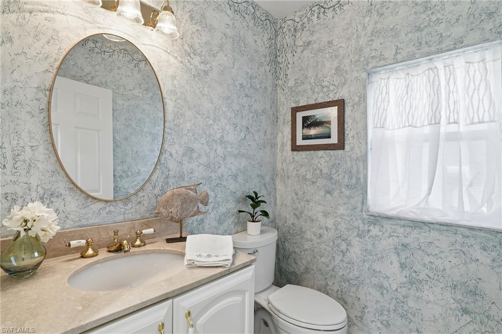 1737 Marsh Run Naples, FL 34109 - Photo 23 of 45 a bathroom with a sink mirror vanity and toilet