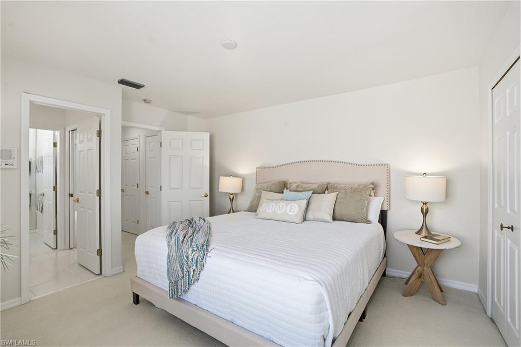 1737 Marsh Run Naples, FL 34109 - Photo 24 of 45 a bedroom with a bed and a lamp