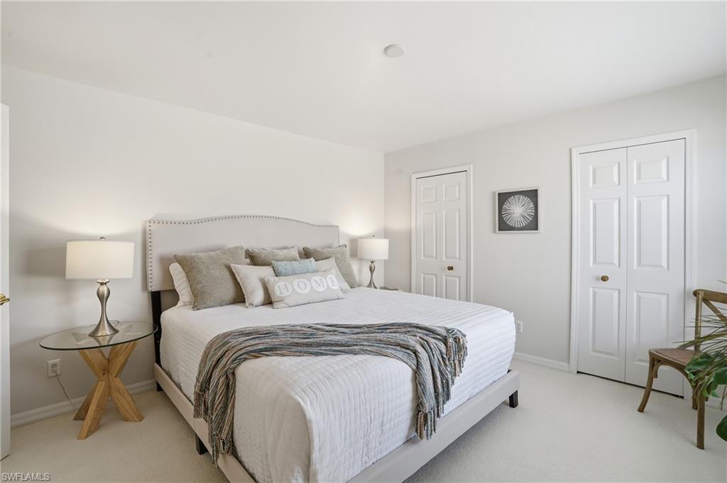 1737 Marsh Run Naples, FL 34109 - Photo 25 of 45 a bedroom with a bed and a lamp
