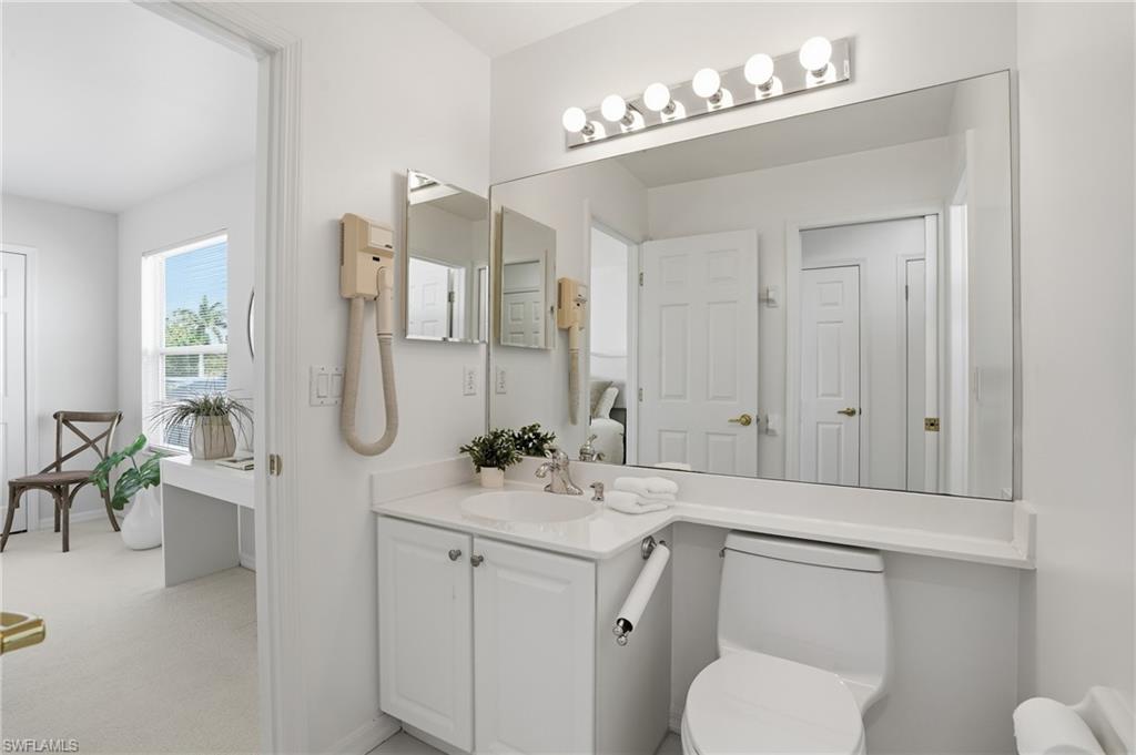 1737 Marsh Run Naples, FL 34109 - Photo 26 of 45 a bathroom with a toilet a sink a tub and mirror