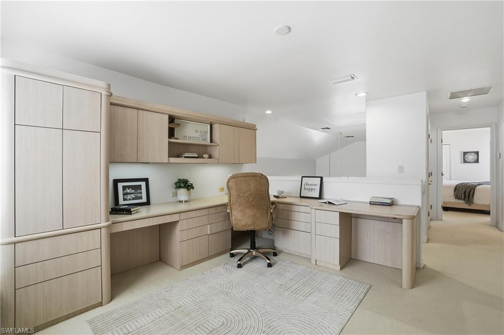 1737 Marsh Run Naples, FL 34109 - Photo 28 of 45 a workspace with a computer on the desk chairs refrigerator and cabinets