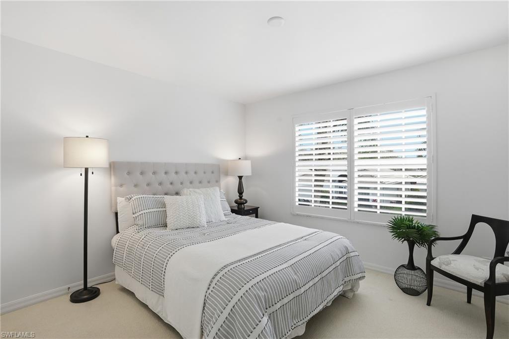 1737 Marsh Run Naples, FL 34109 - Photo 30 of 45 a bedroom with a bed and a chair