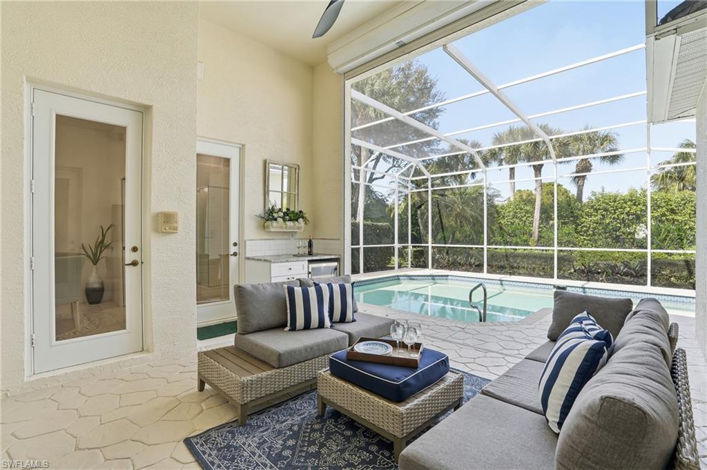 1737 Marsh Run Naples, FL 34109 - Photo 35 of 45 a living room with furniture and a large window