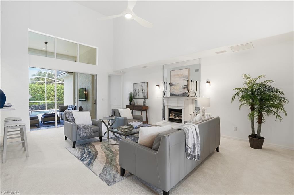 1737 Marsh Run Naples, FL 34109 - Photo 5 of 45 a living room with furniture fireplace and potted plants