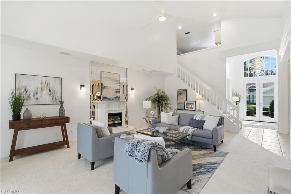 1737 Marsh Run Naples, FL 34109 - Photo 6 of 45 a living room with fireplace furniture and a large window