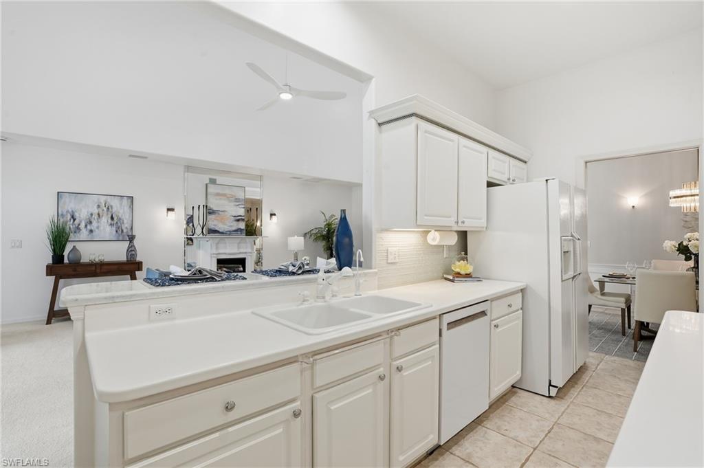 1737 Marsh Run Naples, FL 34109 - Photo 10 of 45 a kitchen with a sink and cabinets