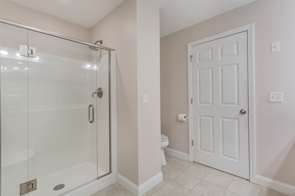 22 Highland Road, Unit 31 Raynham, MA 02767 - Photo 14 of 28 a bathroom with a shower and a glass door