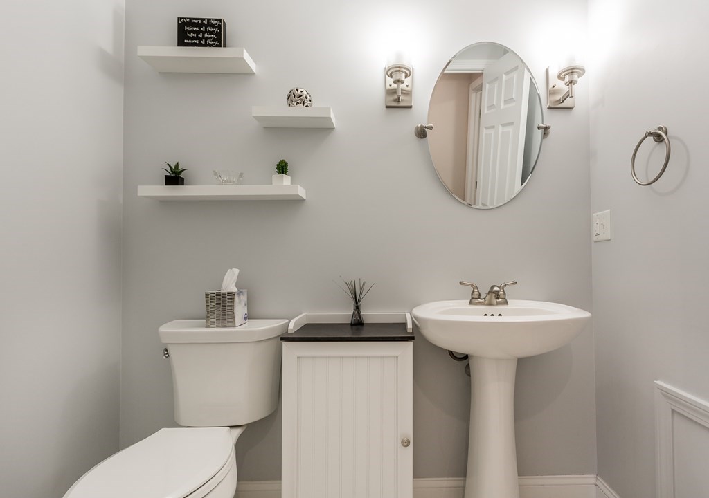 22 Highland Road, Unit 31 Raynham, MA 02767 - Photo 17 of 28 a bathroom with a sink a mirror and toilet