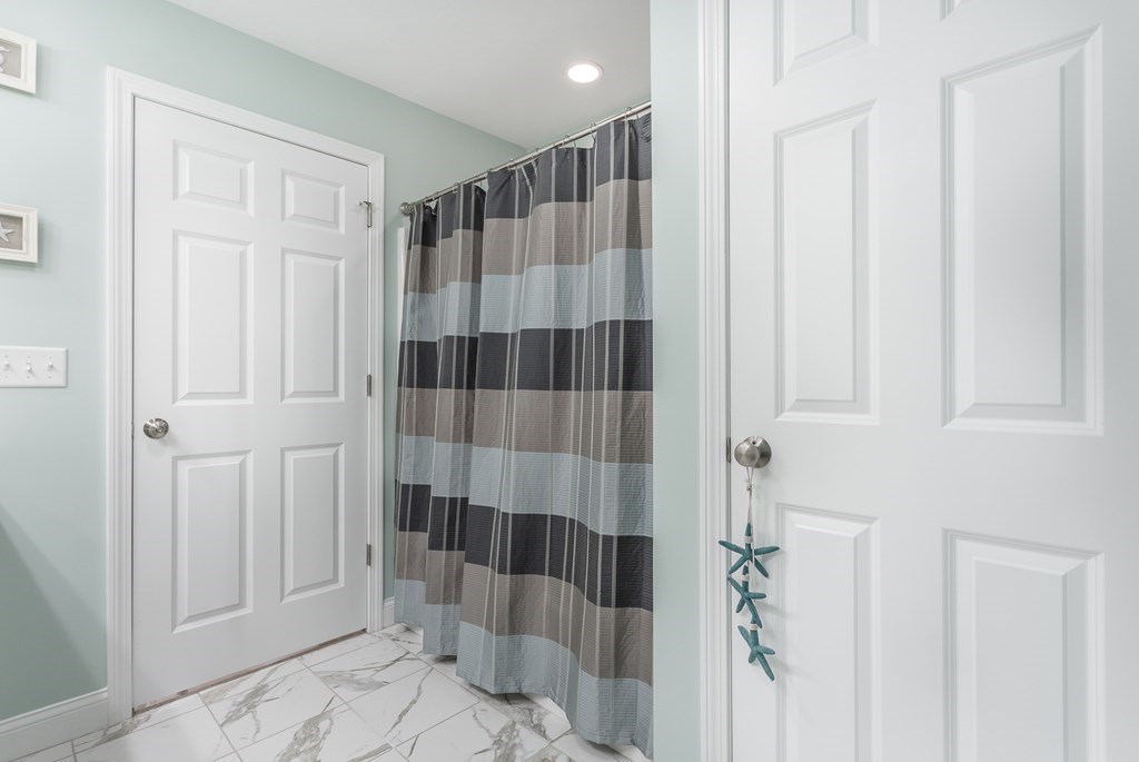 22 Highland Road, Unit 31 Raynham, MA 02767 - Photo 24 of 28 a bathroom with a shower and a sink