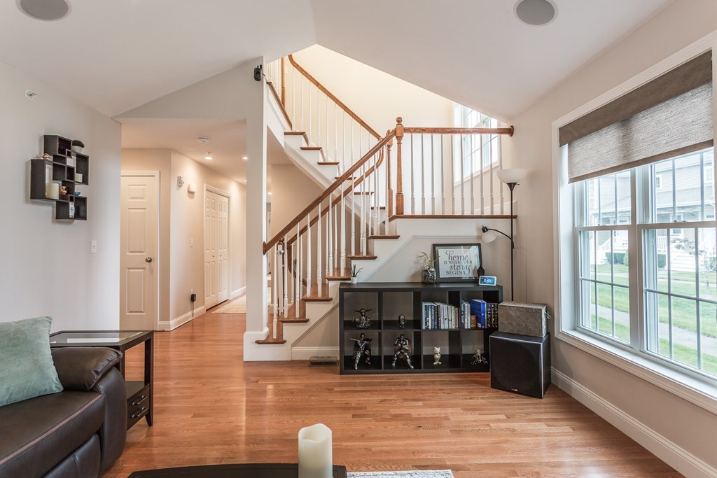 22 Highland Road, Unit 31 Raynham, MA 02767 - Photo 4 of 28 a living room with furniture and wooden floor next to a window