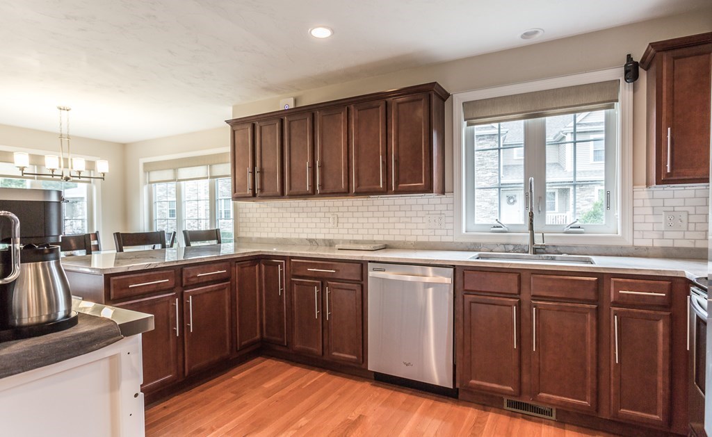 22 Highland Road, Unit 31 Raynham, MA 02767 - Photo 6 of 28 a kitchen with granite countertop sink stove and cabinets