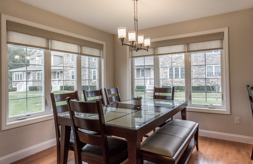 22 Highland Road, Unit 31 Raynham, MA 02767 - Photo 10 of 28 a view of a dining room with furniture a chandelier and wooden floor
