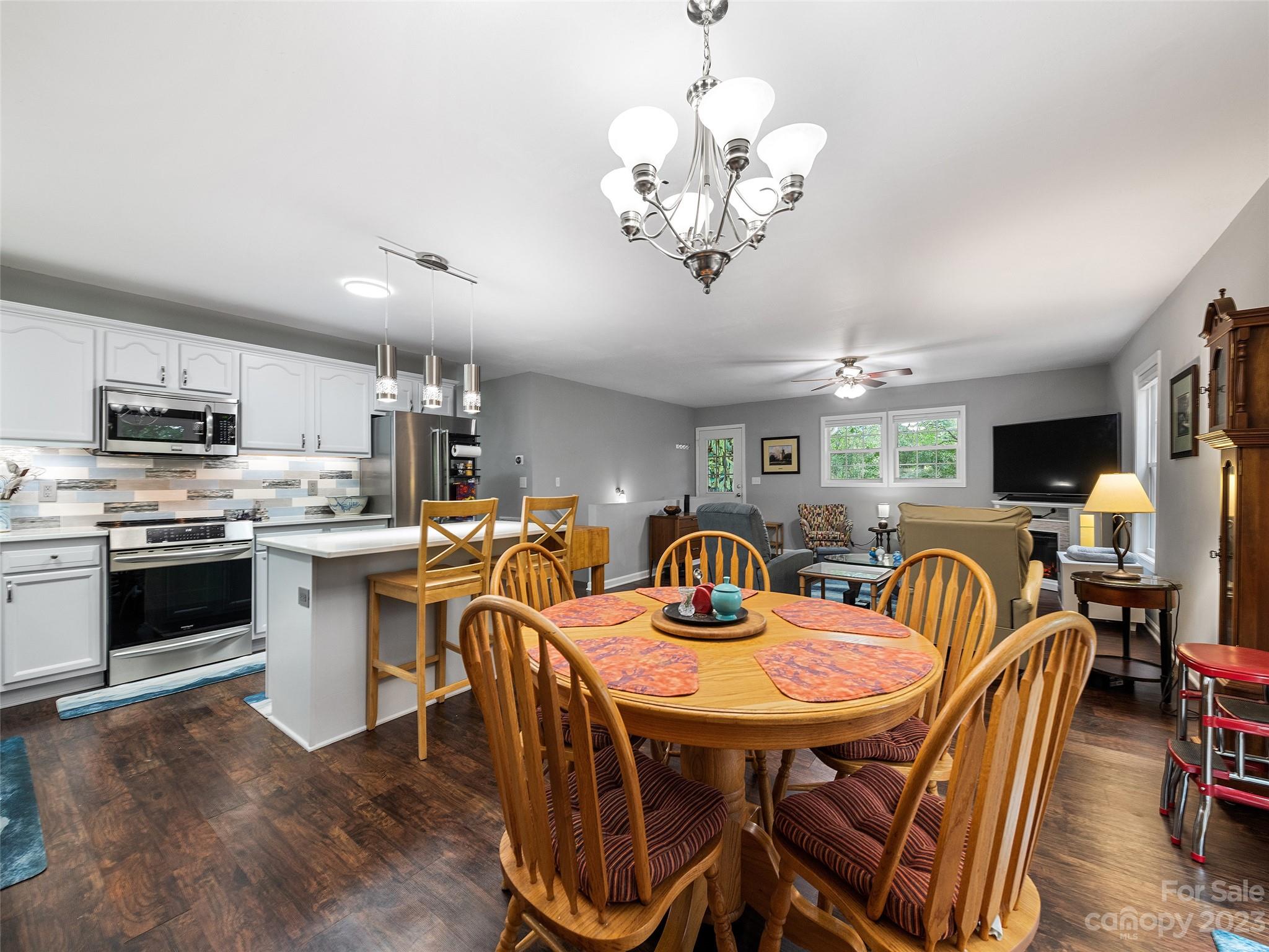 17 Secluded Trail Candler, NC 28715 - Photo 12 of 34 a view of a dining room with furniture a chandelier and wooden floor