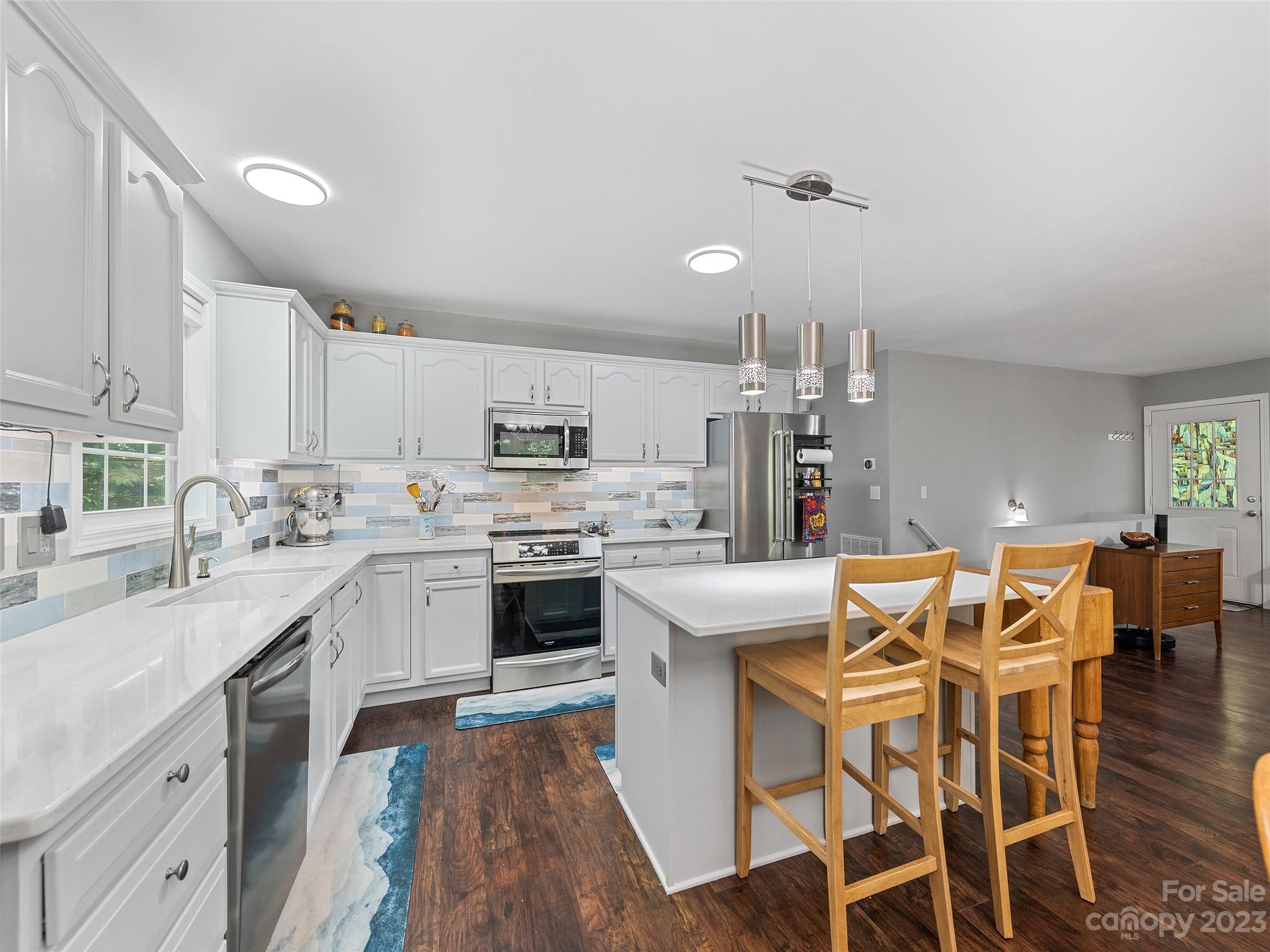 17 Secluded Trail Candler, NC 28715 - Photo 14 of 34 a kitchen with stainless steel appliances kitchen island granite countertop a sink and cabinets