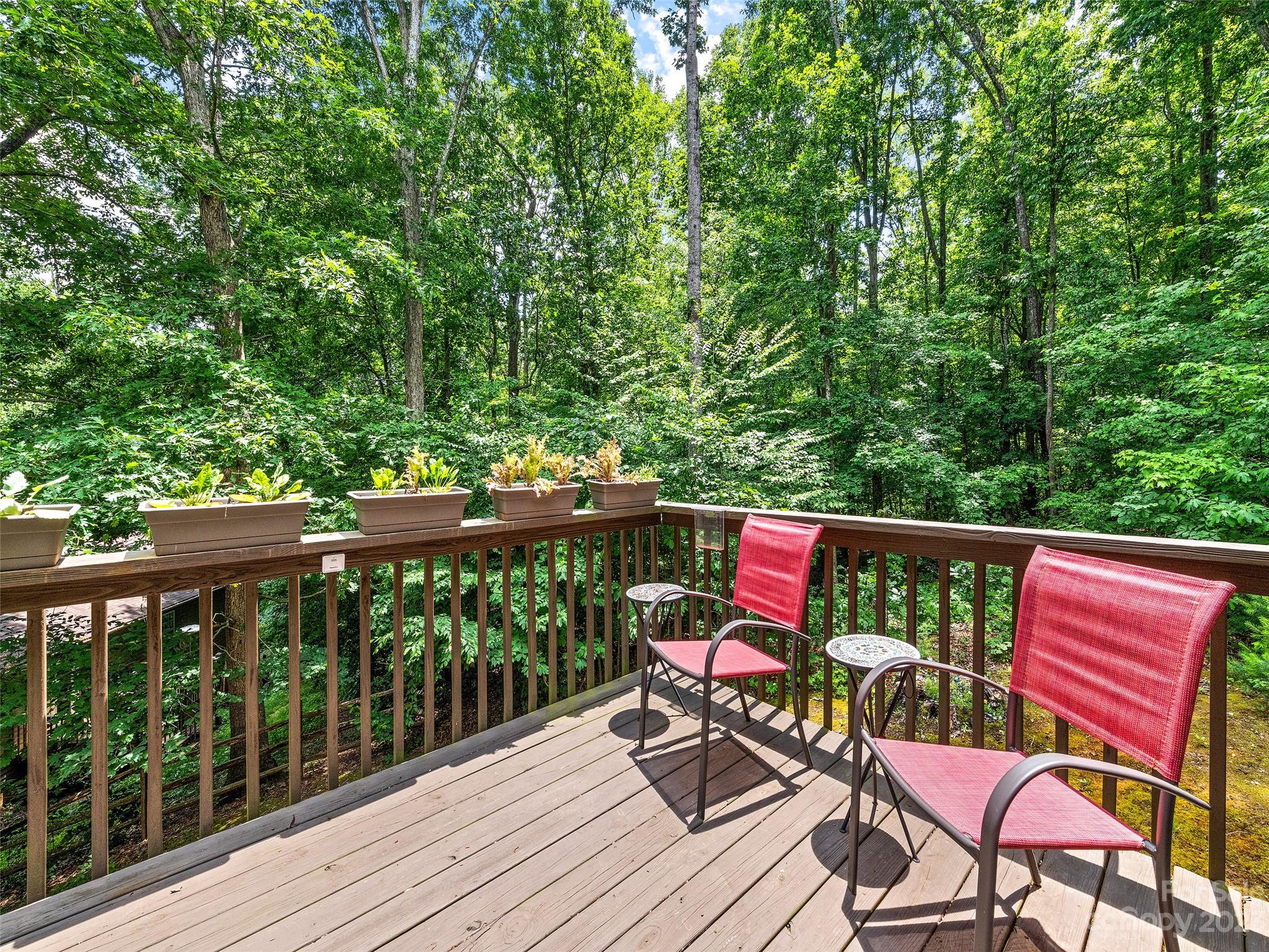 17 Secluded Trail Candler, NC 28715 - Photo 16 of 34 a balcony with wooden floor and outdoor seating