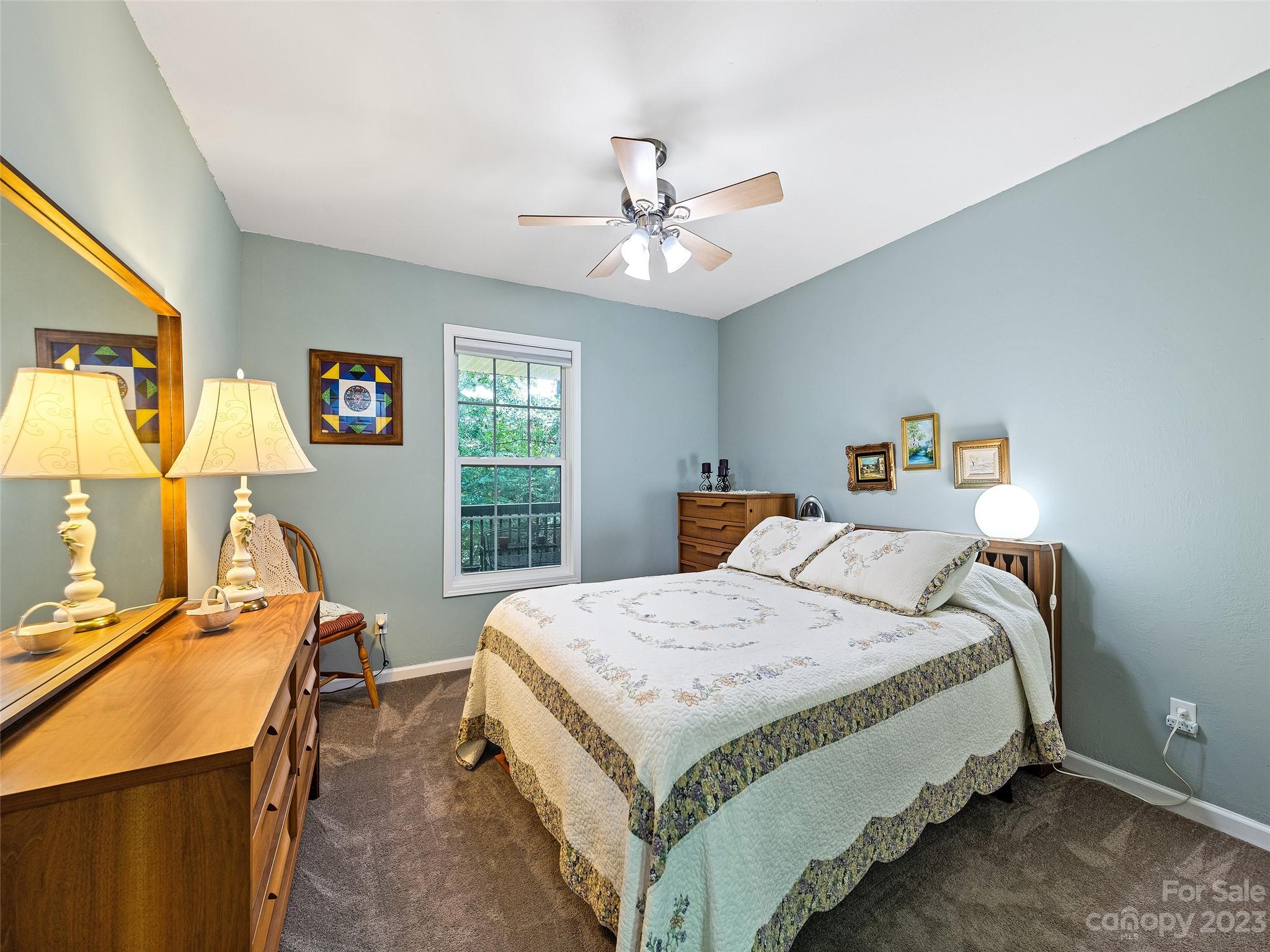 17 Secluded Trail Candler, NC 28715 - Photo 21 of 34 a bedroom with a bed and a table in it