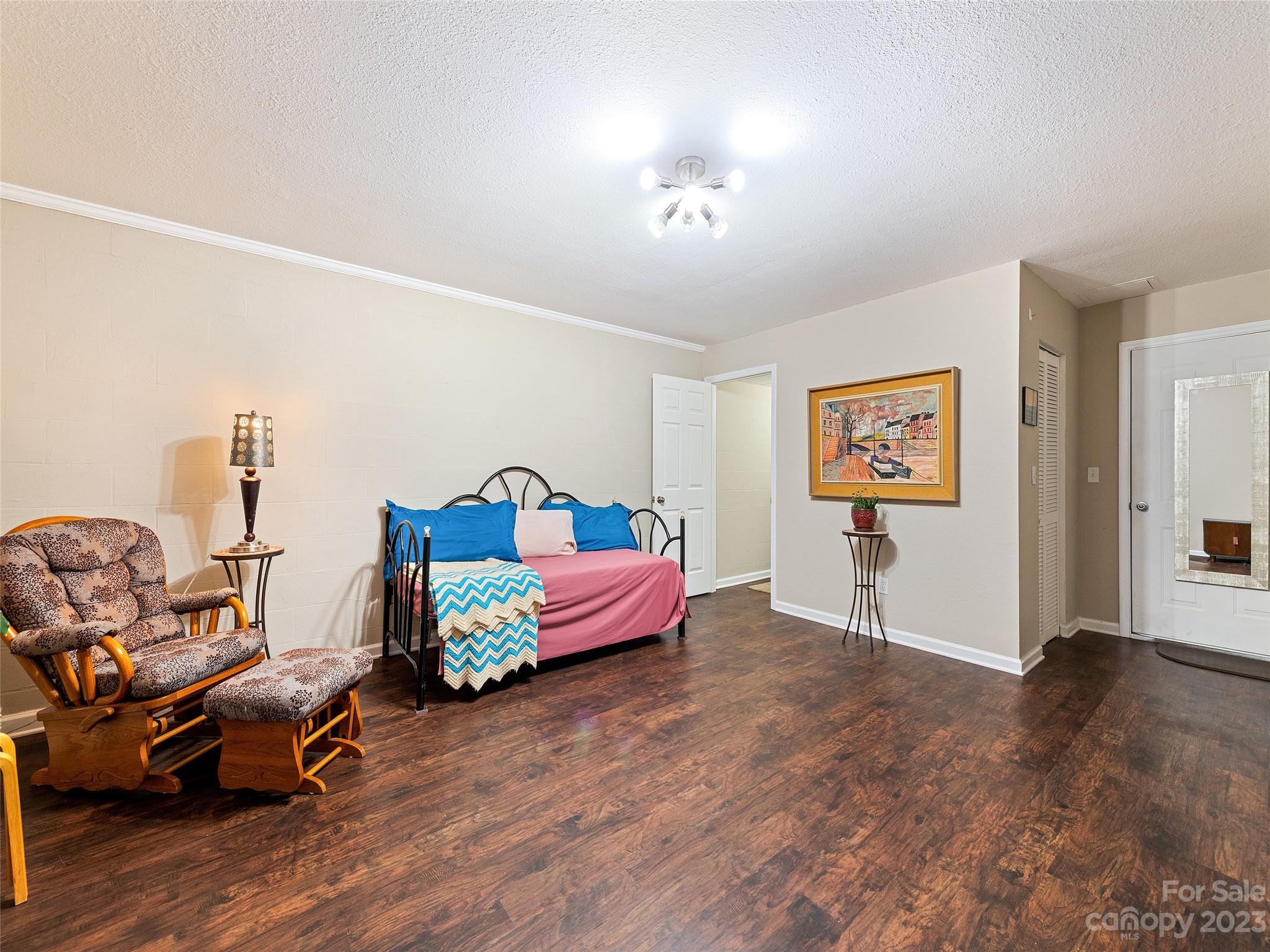 17 Secluded Trail Candler, NC 28715 - Photo 27 of 34 a bedroom with furniture and a wooden floor