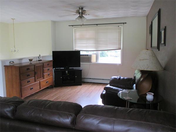 298 Asylum Street Woonsocket, RI 02895 - Photo 7 of 11 a living room with furniture and a flat screen tv
