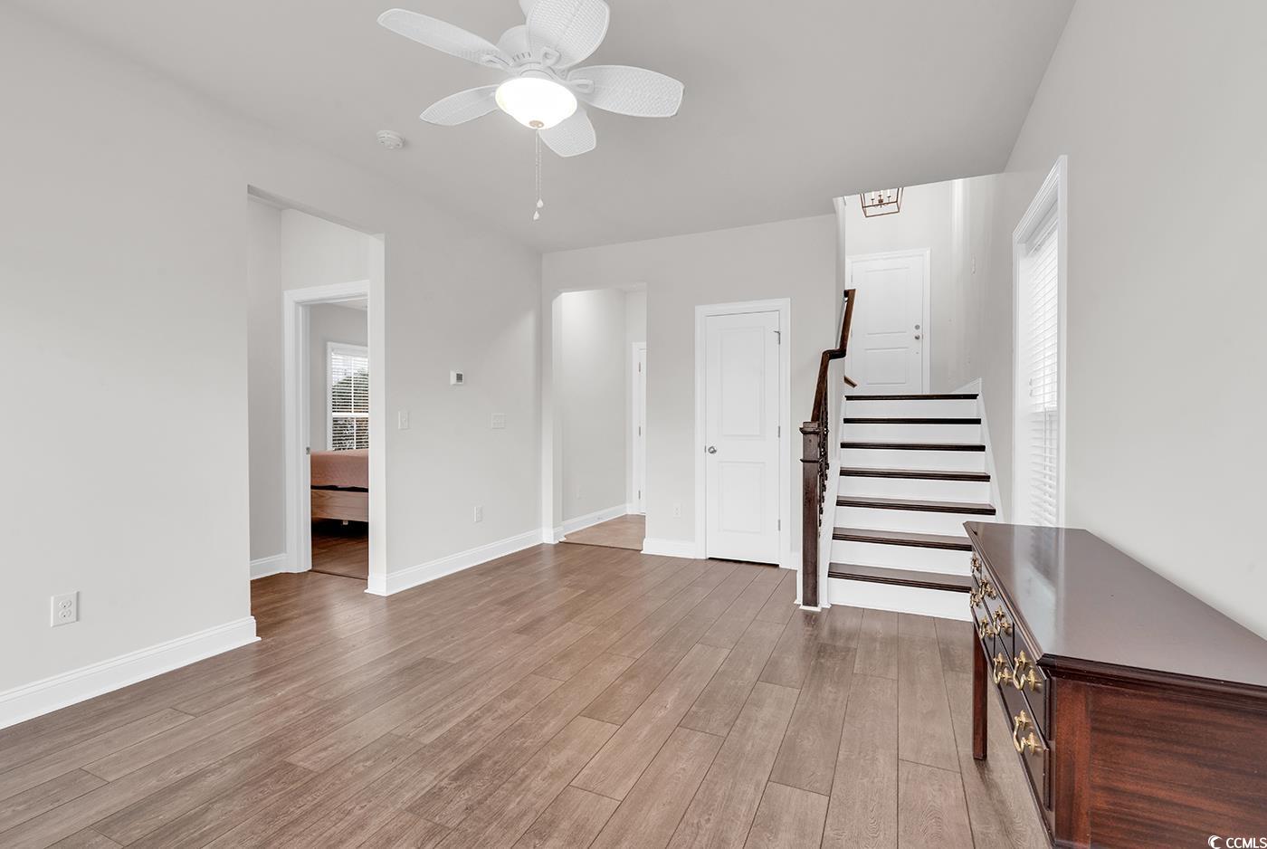 535 Chanted Drive Murrells Inlet, SC 29576 - Photo 21 of 37 Unfurnished living room with stairway, light wood finished floors, and a ceiling fan