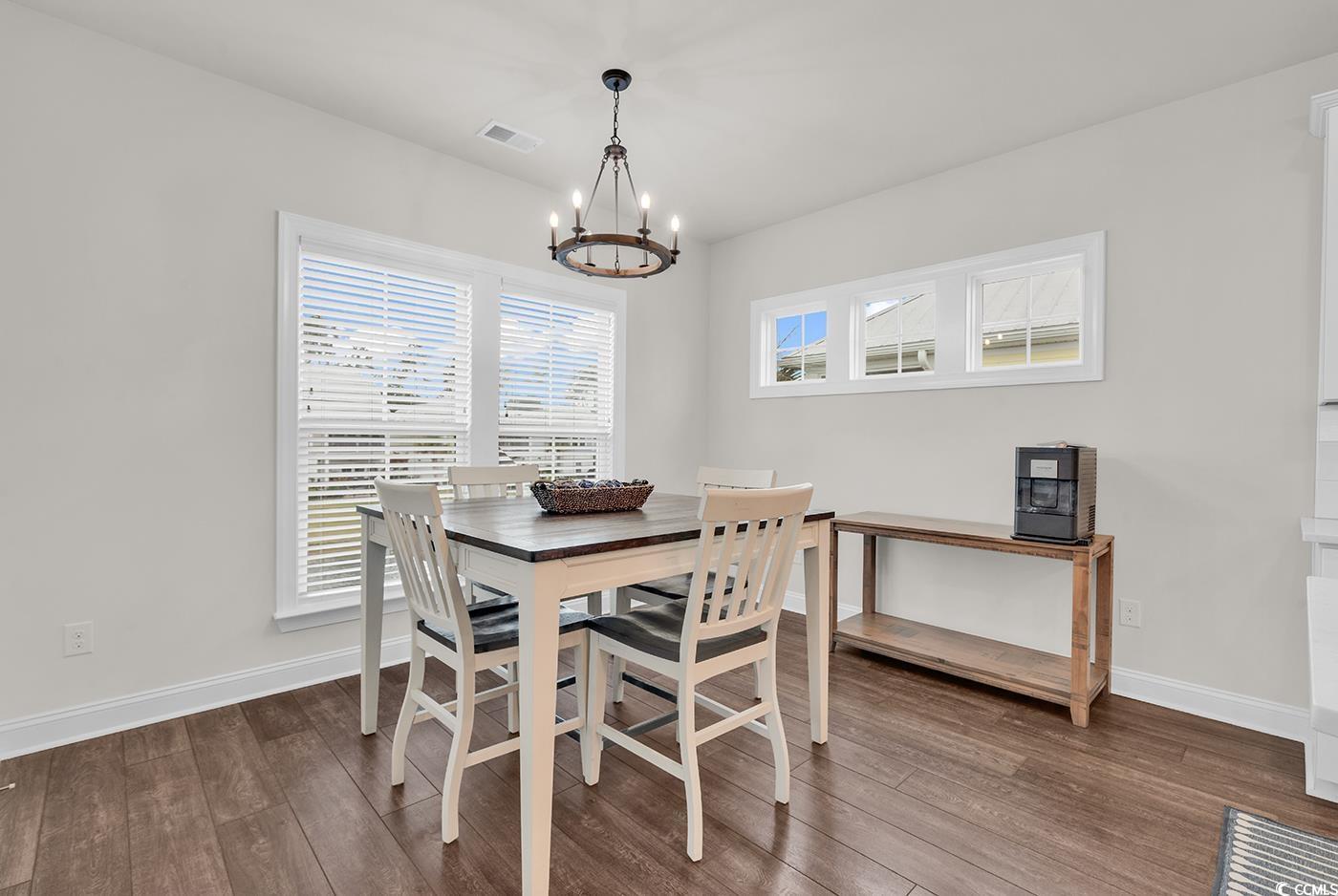 535 Chanted Drive Murrells Inlet, SC 29576 - Photo 9 of 37 Dining room featuring dark wood-style floors and a chandelier