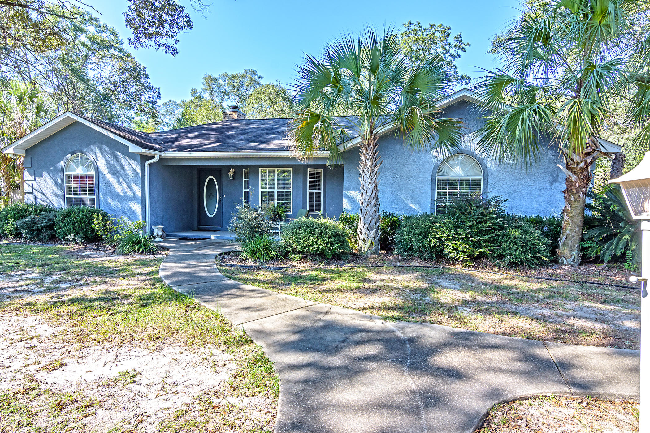 7262 Old River Road Baker, FL 32531 - Photo 1 of 63 a front view of house with yard and trees around