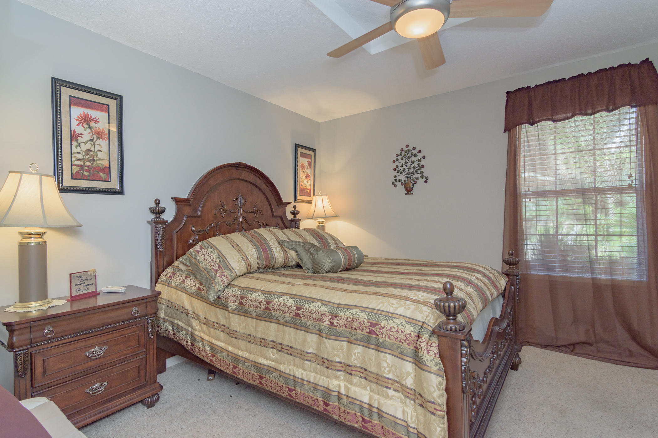 7262 Old River Road Baker, FL 32531 - Photo 12 of 63 a bedroom with a bed and a lamp on dresser