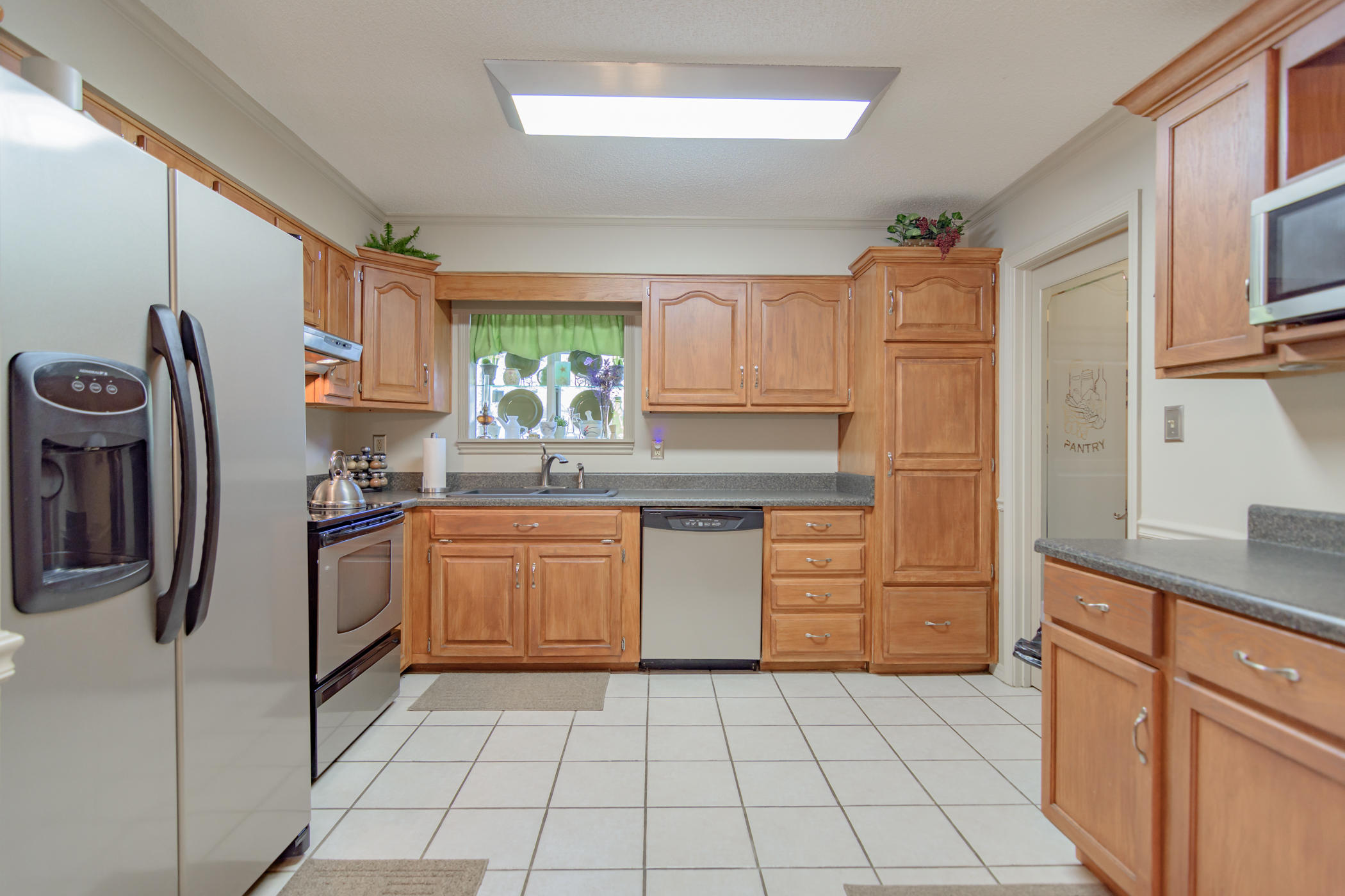 7262 Old River Road Baker, FL 32531 - Photo 18 of 63 a kitchen with stainless steel appliances granite countertop a refrigerator and a sink