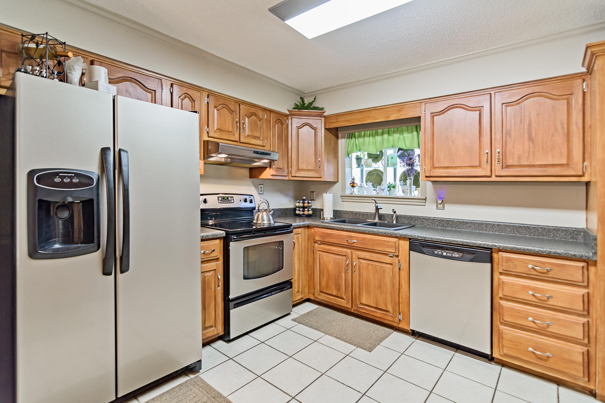 7262 Old River Road Baker, FL 32531 - Photo 19 of 63 a kitchen with granite countertop stainless steel appliances a refrigerator sink and microwave