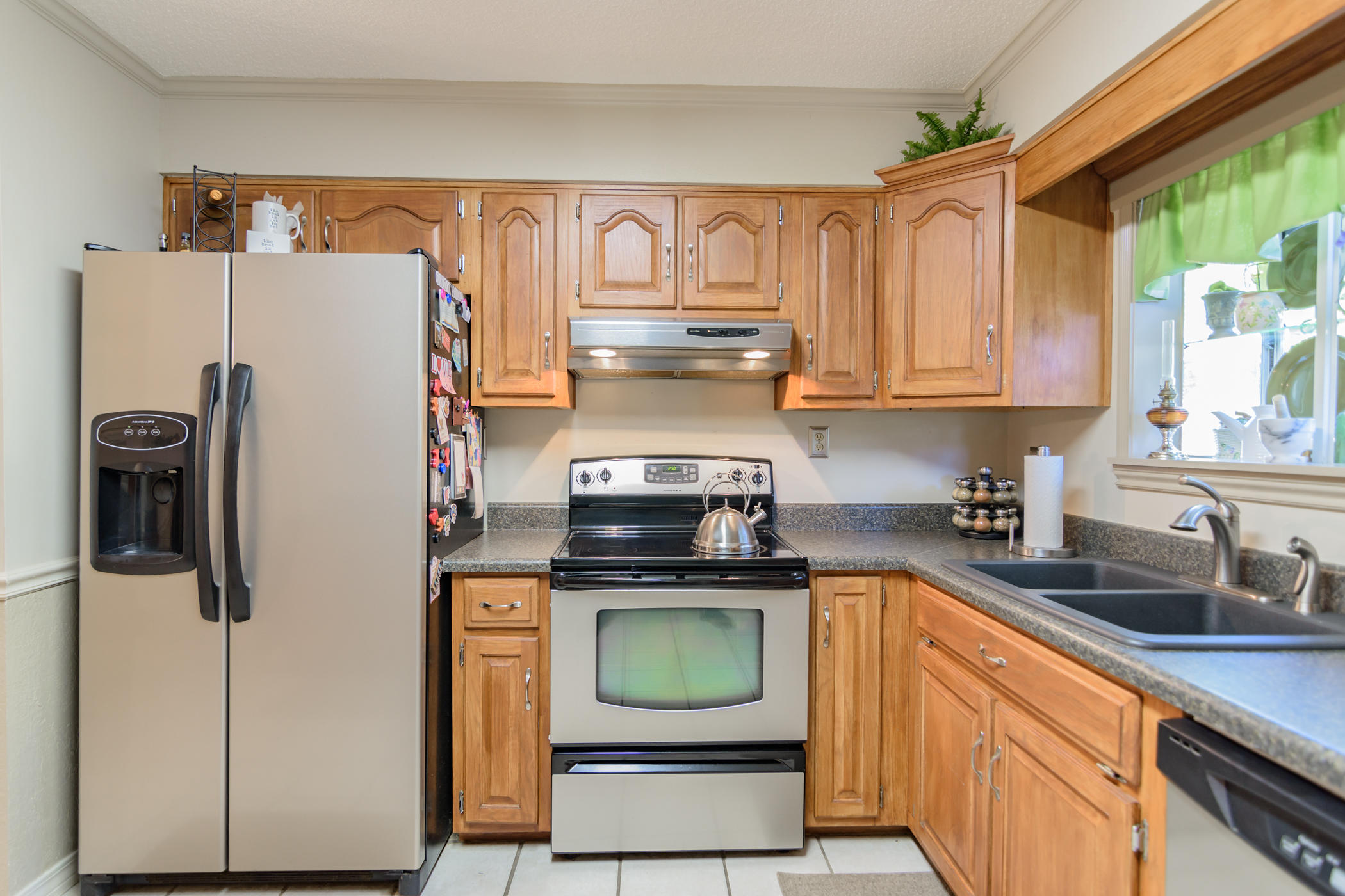 7262 Old River Road Baker, FL 32531 - Photo 20 of 63 a kitchen with stainless steel appliances granite countertop a refrigerator a stove a sink and dishwasher