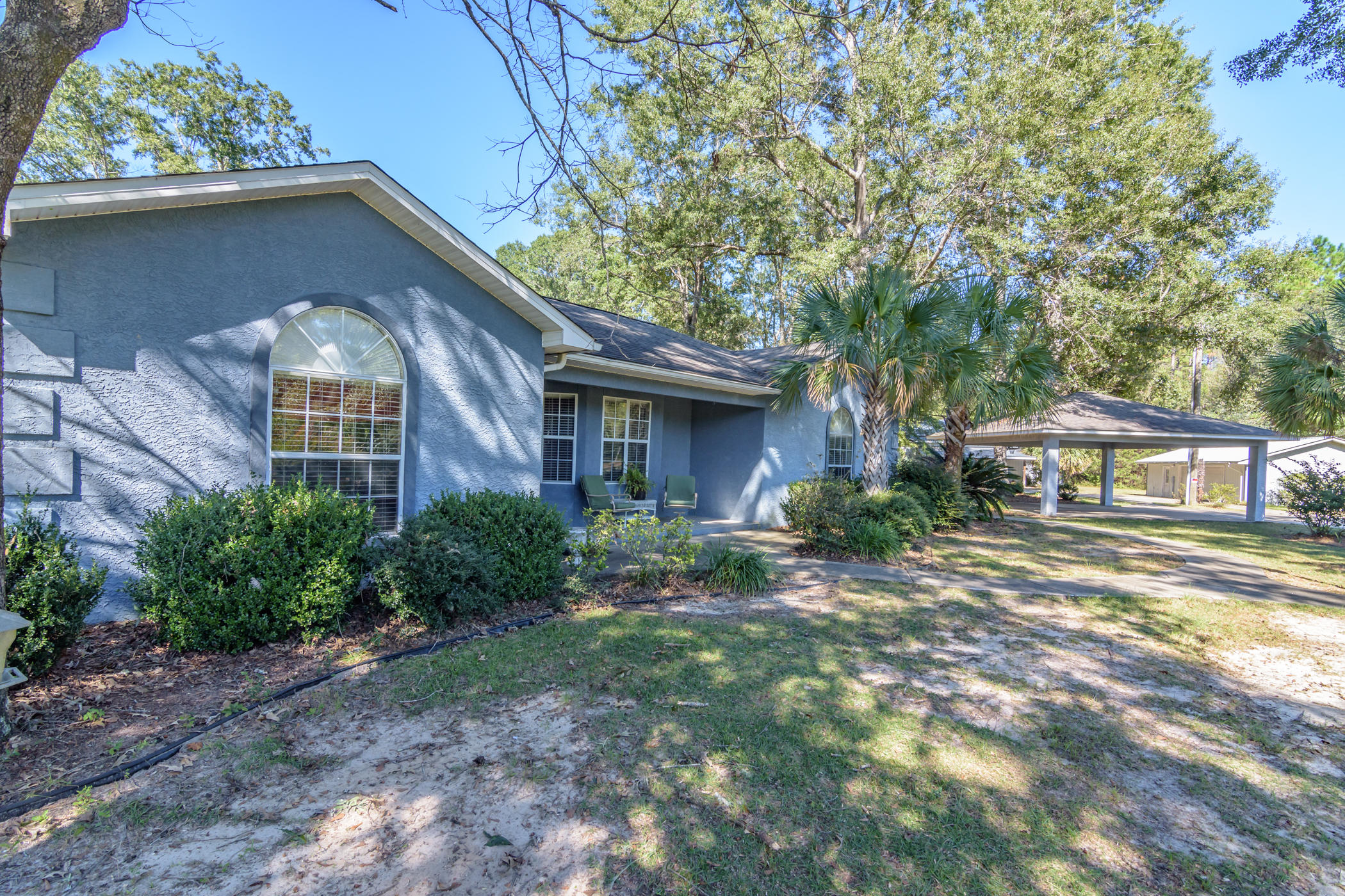 7262 Old River Road Baker, FL 32531 - Photo 3 of 63 a front view of a house with garden