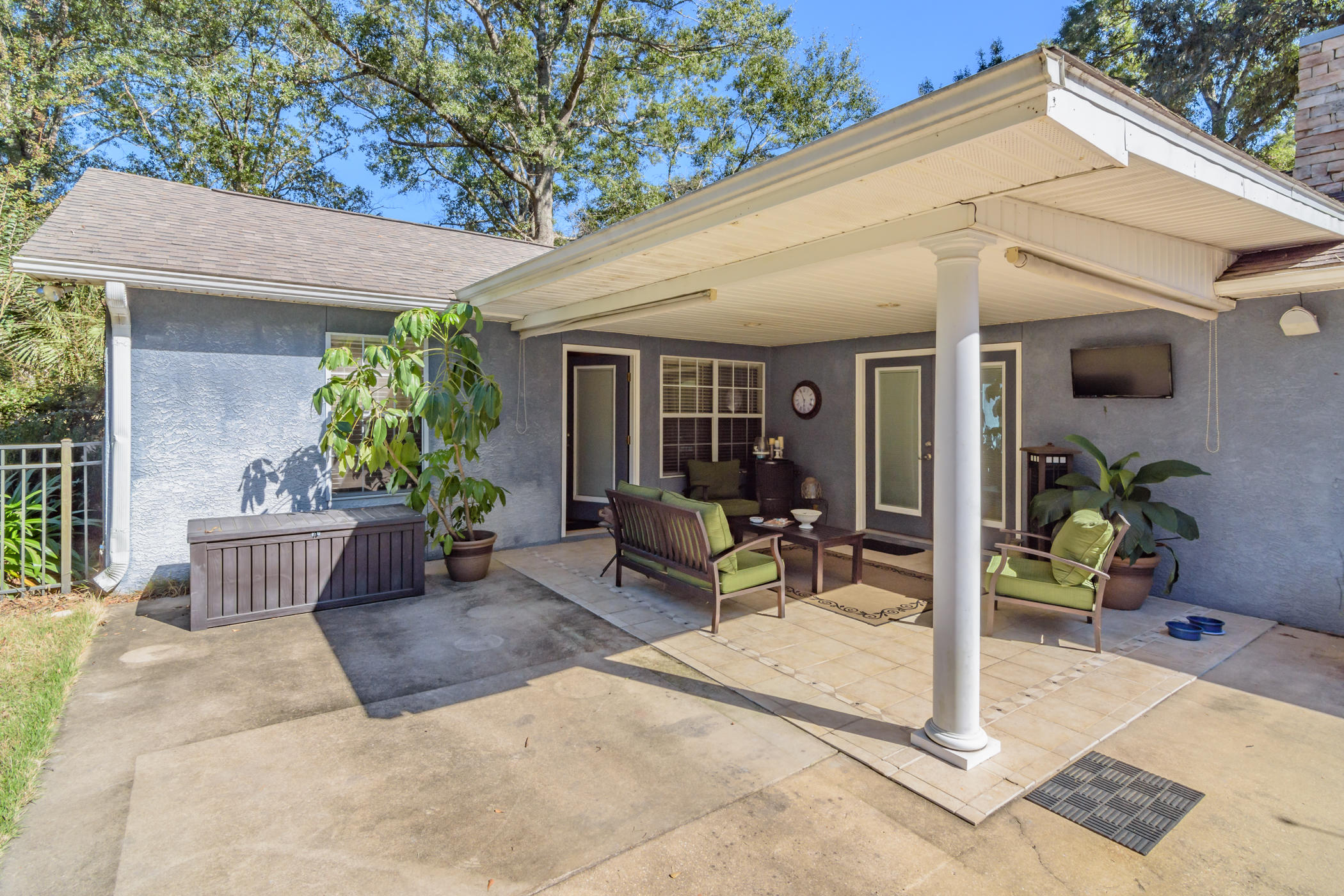 7262 Old River Road Baker, FL 32531 - Photo 28 of 63 a view of a patio with table and chairs potted plants and floor to ceiling window