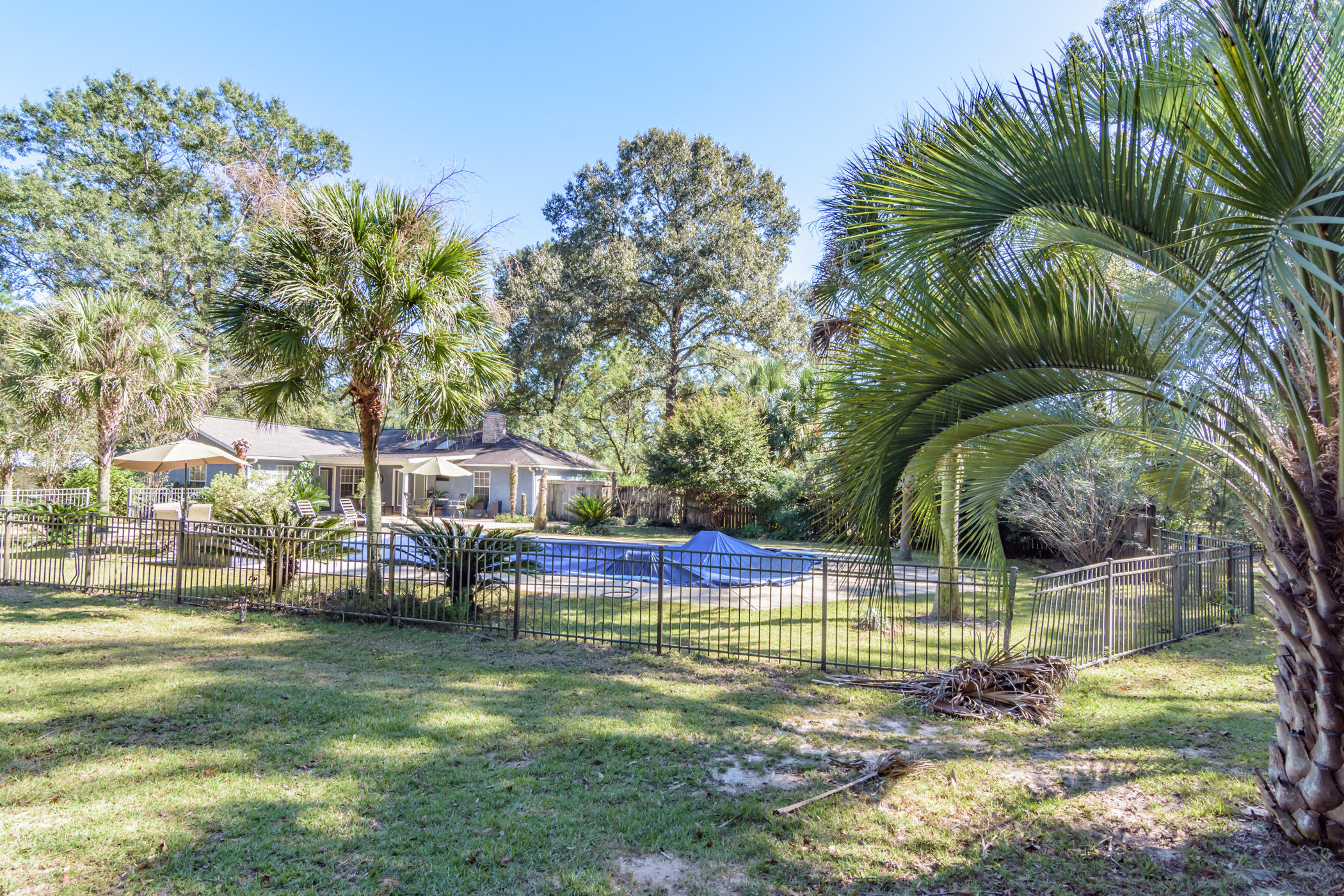 7262 Old River Road Baker, FL 32531 - Photo 29 of 63 a view of a swimming pool with a patio