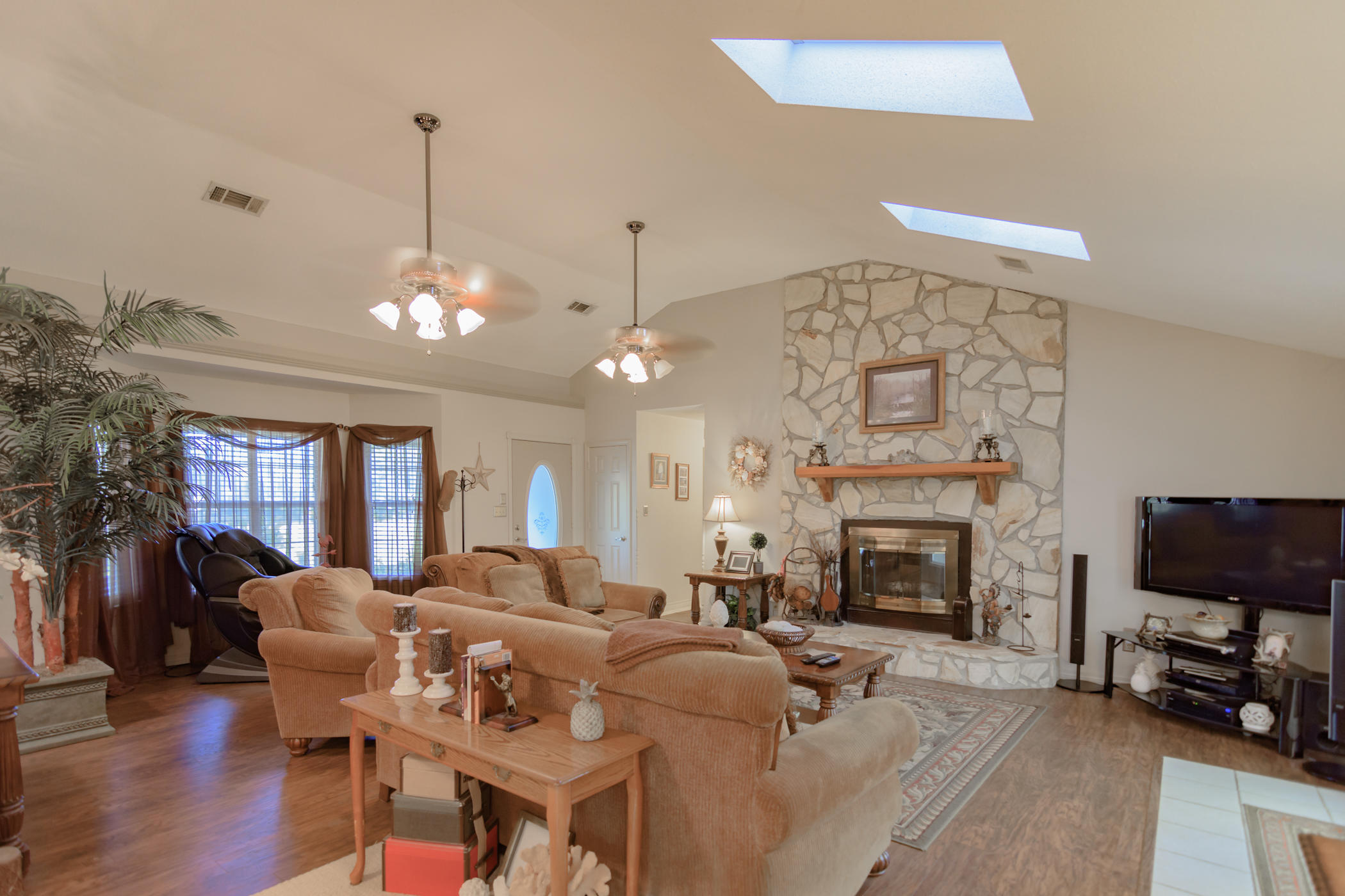 7262 Old River Road Baker, FL 32531 - Photo 4 of 63 a living room with furniture a fireplace and a flat screen tv