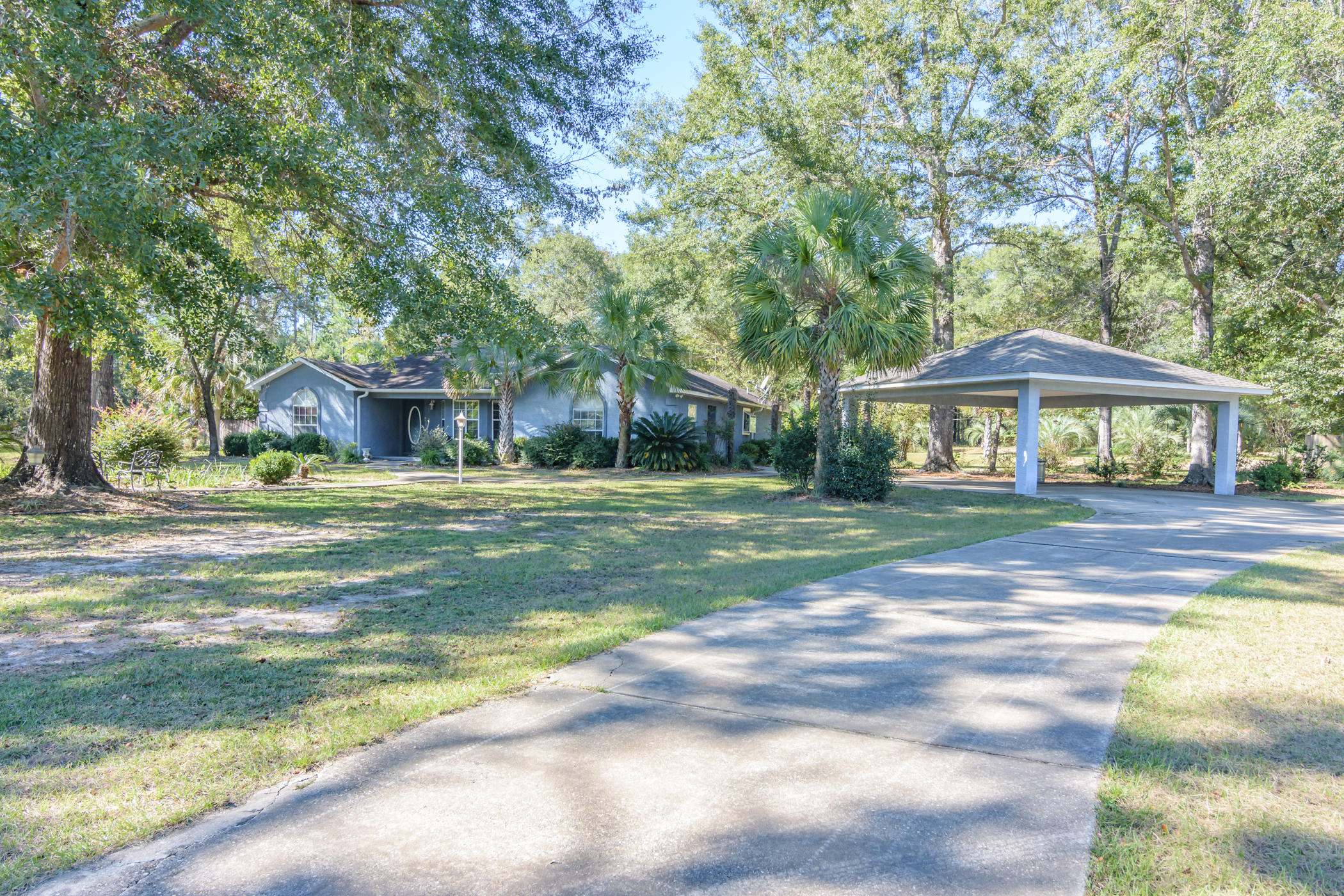 7262 Old River Road Baker, FL 32531 - Photo 31 of 63 a front view of a house with a yard