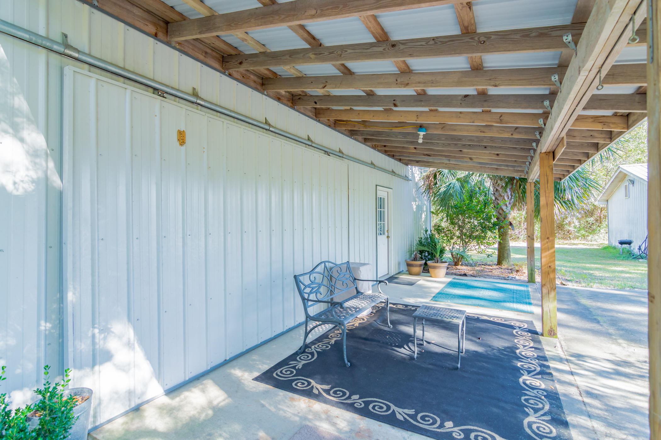 7262 Old River Road Baker, FL 32531 - Photo 44 of 63 a outdoor space with the couches and dining table with the entryway view