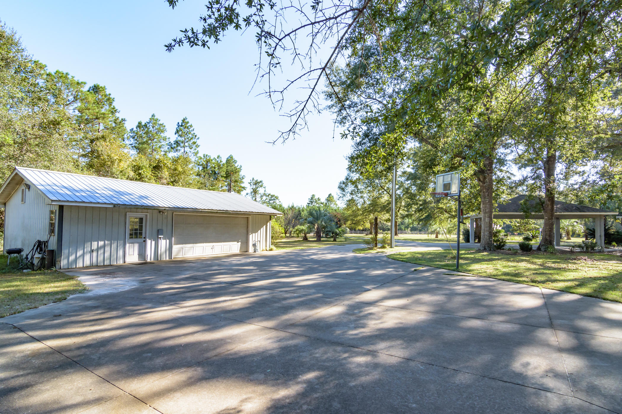 7262 Old River Road Baker, FL 32531 - Photo 45 of 63 a view of a house with a big yard and large trees