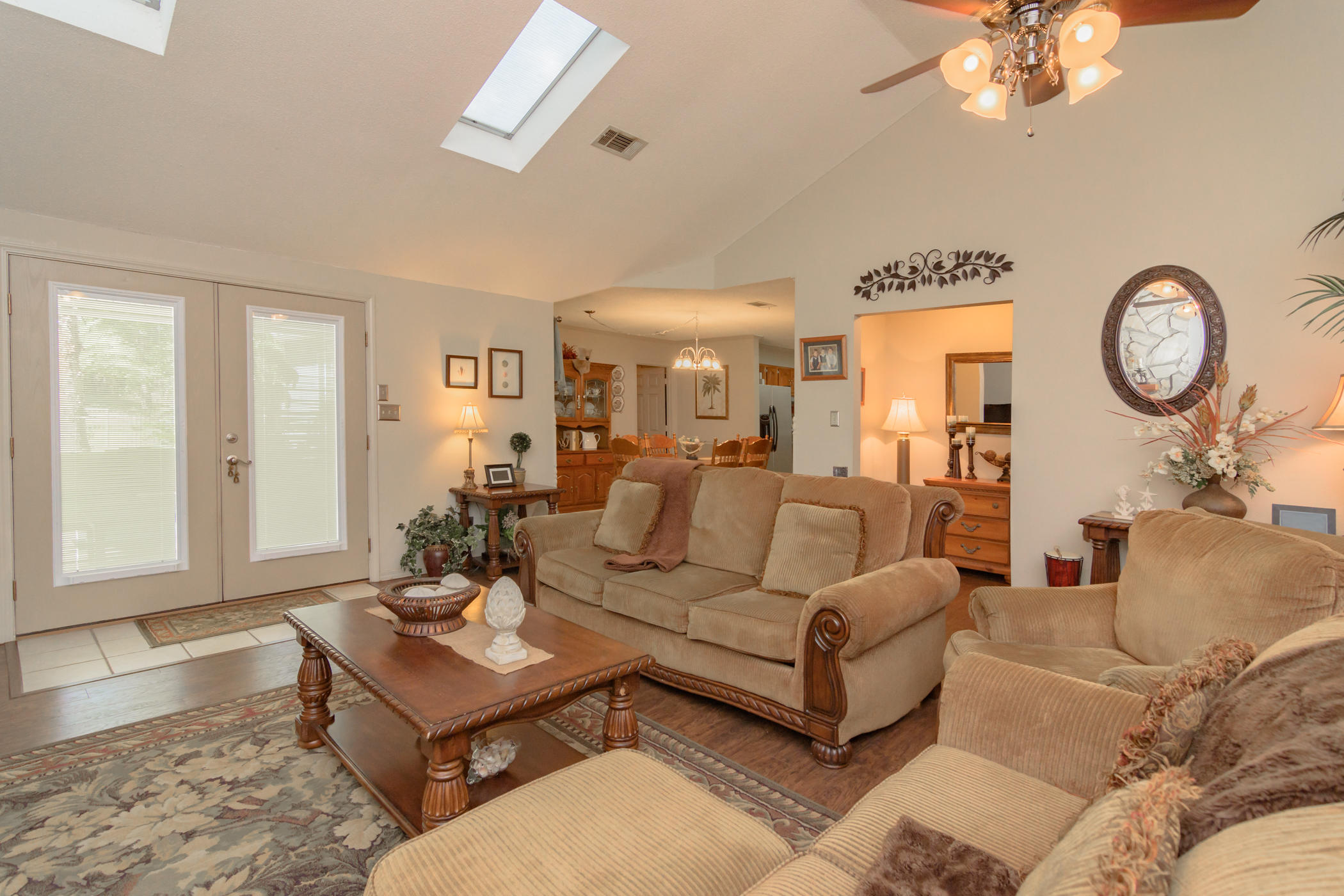 7262 Old River Road Baker, FL 32531 - Photo 6 of 63 a living room with furniture a chandelier and a window