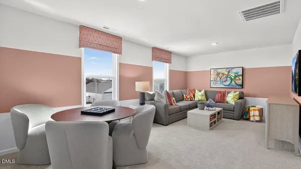 a living room with furniture and painting on the wall