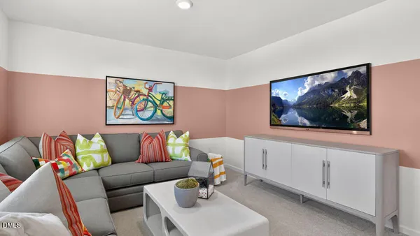 a living room with furniture and a wall painting