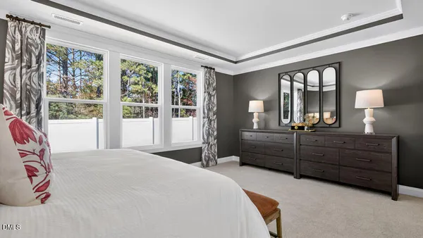 a bedroom with a bed cabinet and window