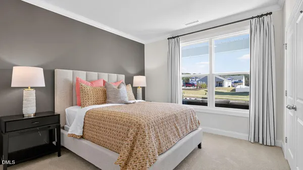 a bedroom with a large bed and a night stand