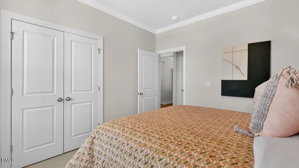 a bedroom with a bed and a mirror