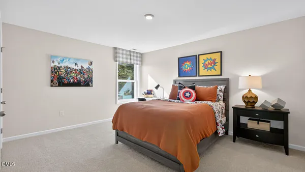 a bedroom with a bed and wall painting