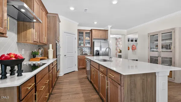 a kitchen with counter top space sink stove and cabinets
