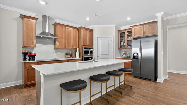 a kitchen with stainless steel appliances granite countertop a sink a stove and a refrigerator