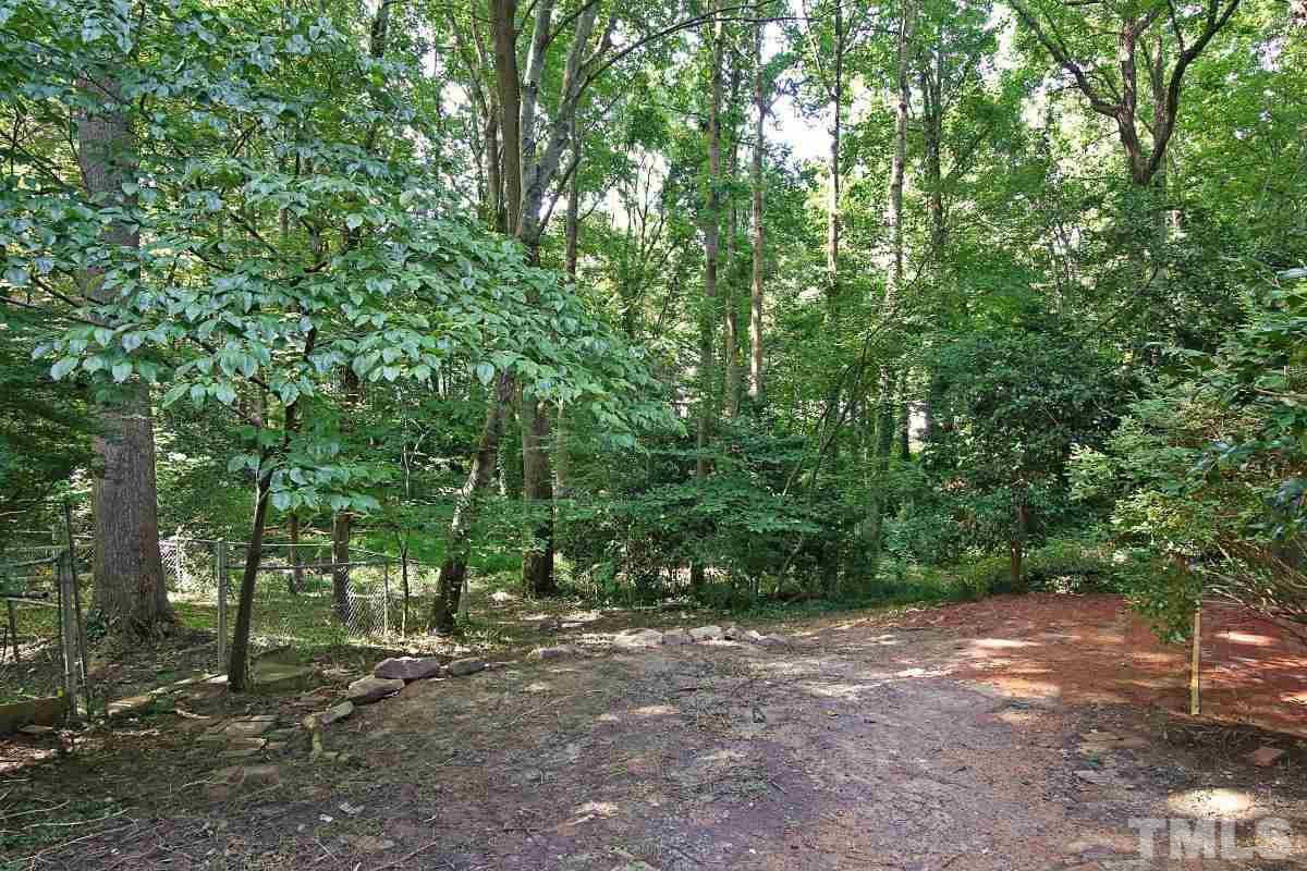 7700 Greentree Court Raleigh, NC 27615 - Photo 6 of 25 a view of a forest with trees in the background