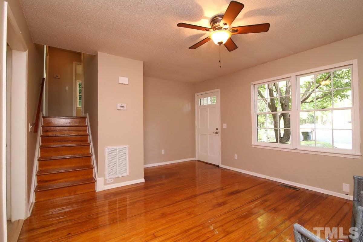 7700 Greentree Court Raleigh, NC 27615 - Photo 10 of 25 a view of an empty room with wooden floor and a window