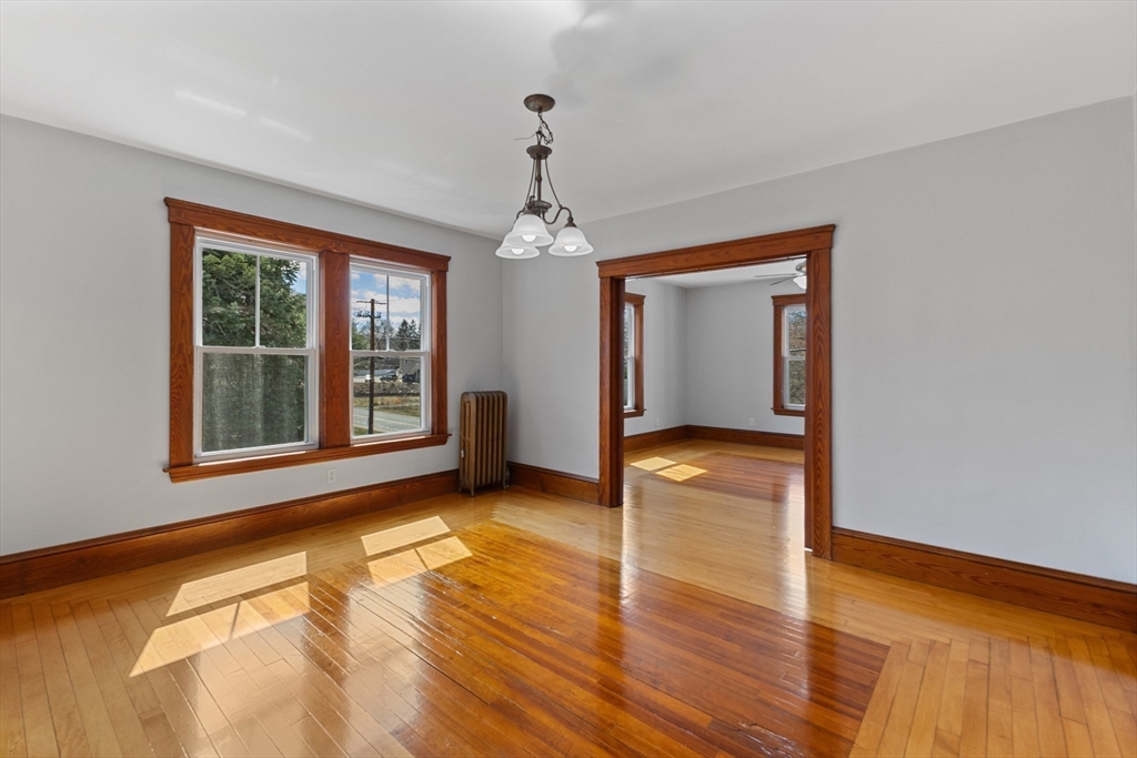 183 Pleasant Street, Unit 2 Grafton, MA 01560 - Photo 11 of 34 a view of an empty room with wooden floor and a window