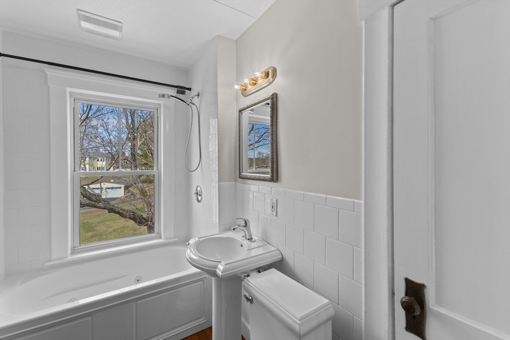 183 Pleasant Street, Unit 2 Grafton, MA 01560 - Photo 19 of 34 a bathroom with a sink and a mirror