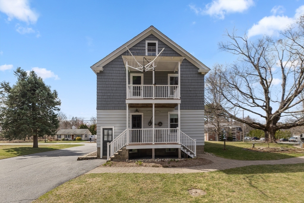 183 Pleasant Street, Unit 2 Grafton, MA 01560 - Photo 27 of 34 a front view of a house with a yard